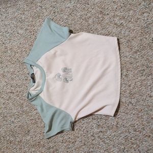 A mint green and beige mushroom print T-shirt